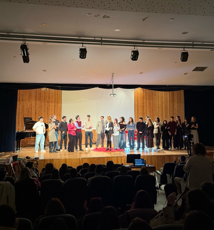 A group of people on a stage AI-generated content may be incorrect.